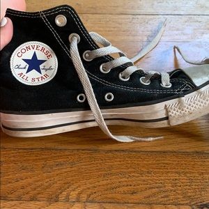 Worn black high top converse